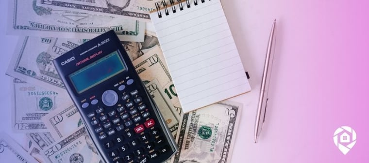 Pile of money with a calculator and notebook to calculate using retirement funds to buy an investment property.