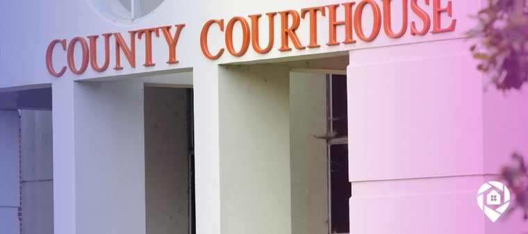 Front of courthouse with "county courthouse" written in orange on the facade