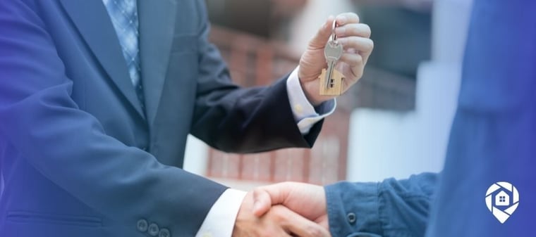 Real estate investor handing over property keys after closing a wholesale deal.