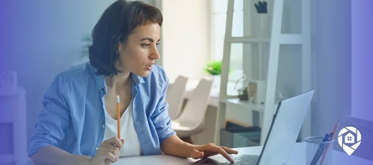 Real estate professional using a laptop to manage virtual assistants for lead generation and wholesaling tasks.