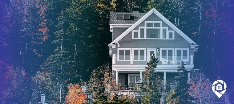 Modern gray house surrounded by trees in Knoxville, Tennessee, representing a successful real estate flip turned rental investment.