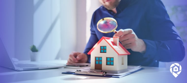 Real estate investor analyzing property deal using model house and magnifying glass, ARV and repair cost evaluation concept