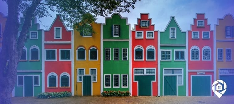Colorful row houses representing rental property investment and real estate portfolio diversity.
