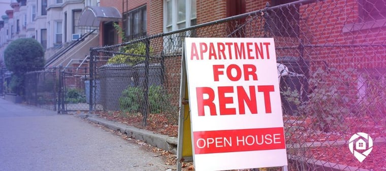 Apartment for rent sign in front of a row of available units