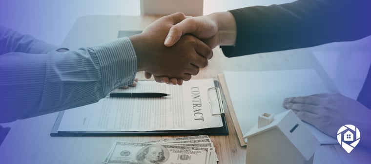 Two real estate investors shaking hands over a contract and cash deal, closing a property sale without marketing.