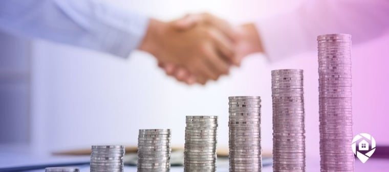 Picture of coin stacks in front of two people shaking hands in the background for how to fund real estate deals.