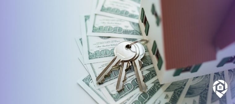 House keys on cash representing real estate wholesaling profits.
