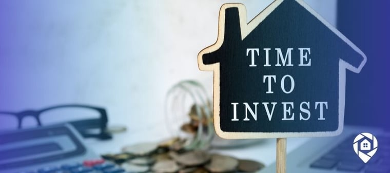 Time to invest in real estate sign with coins and calculator – start flipping, renting, or wholesaling properties for financial freedom.