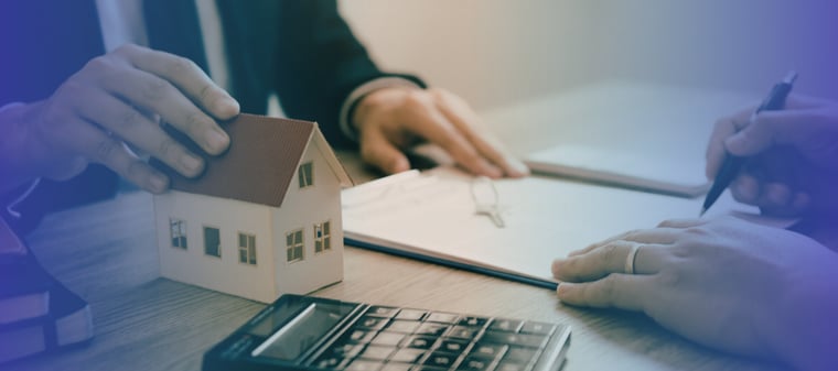 Person using a calculator to review home financing for a subject to a mortgage real estate deal.