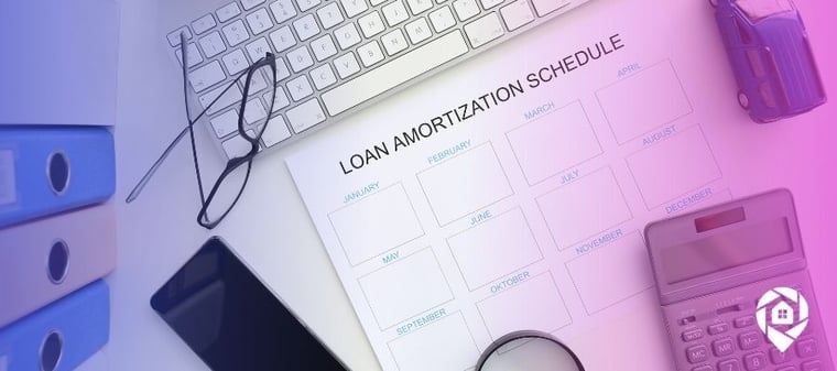 An amortization schedule on a desk.