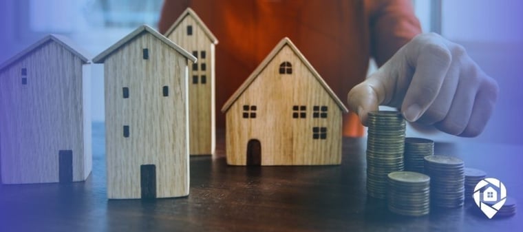 Novation strategy in real estate – wooden houses and stacked coins representing selling unsellable properties for profit.