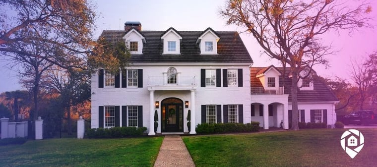 A white house with black roof and black shutter to show a house that has a title 