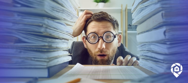 Overwhelmed real estate investor buried in paperwork, showing why a transaction coordinator helps deals close.